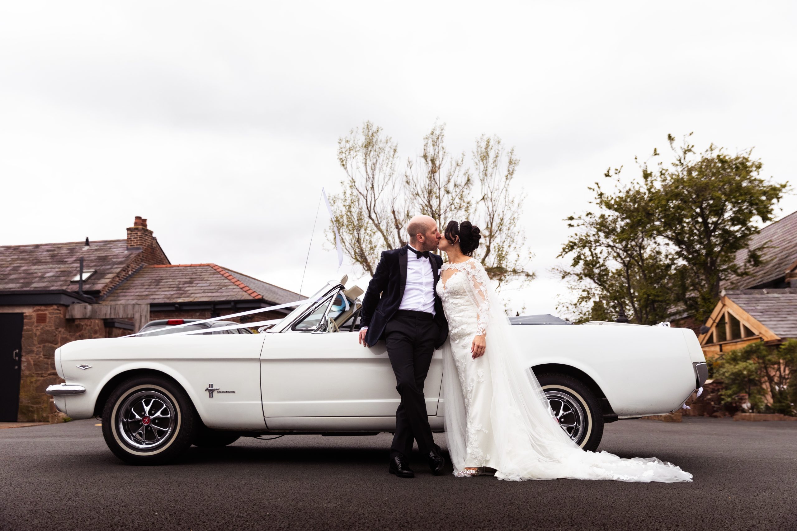 Laura & Sean in front of a classic mustang at the Manor in Greasy, Wirral